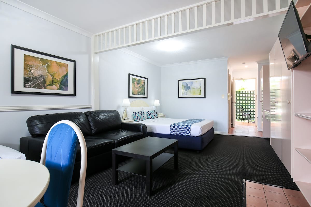 Premium bedding, desk, laptop workspace, blackout drapes