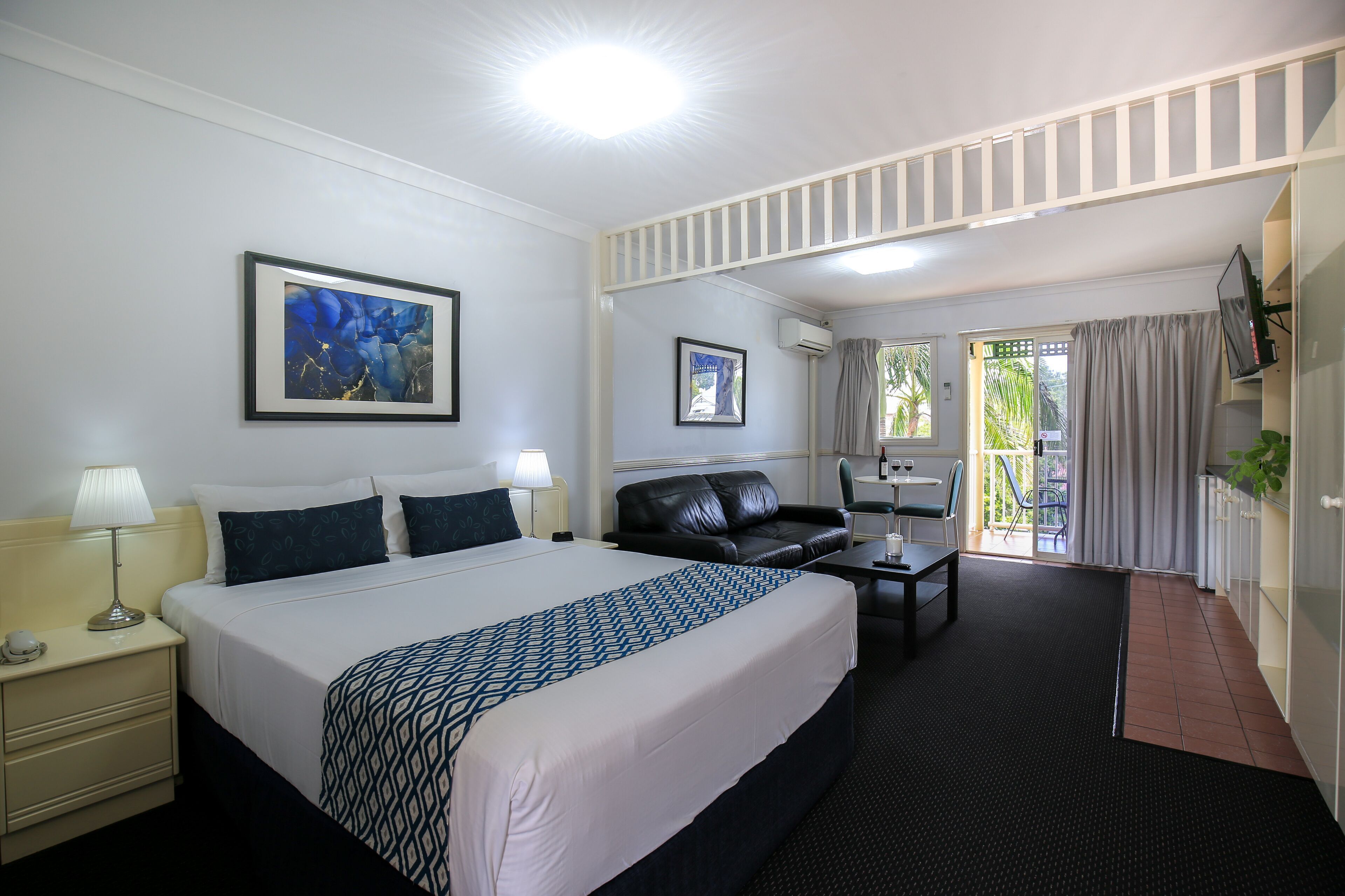 Premium bedding, desk, laptop workspace, blackout drapes