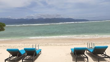 On the beach, sun loungers, beach towels, beach bar