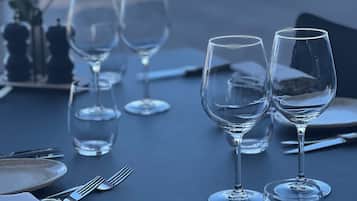 A table set for dining with wine glasses, cutlery, and plates.