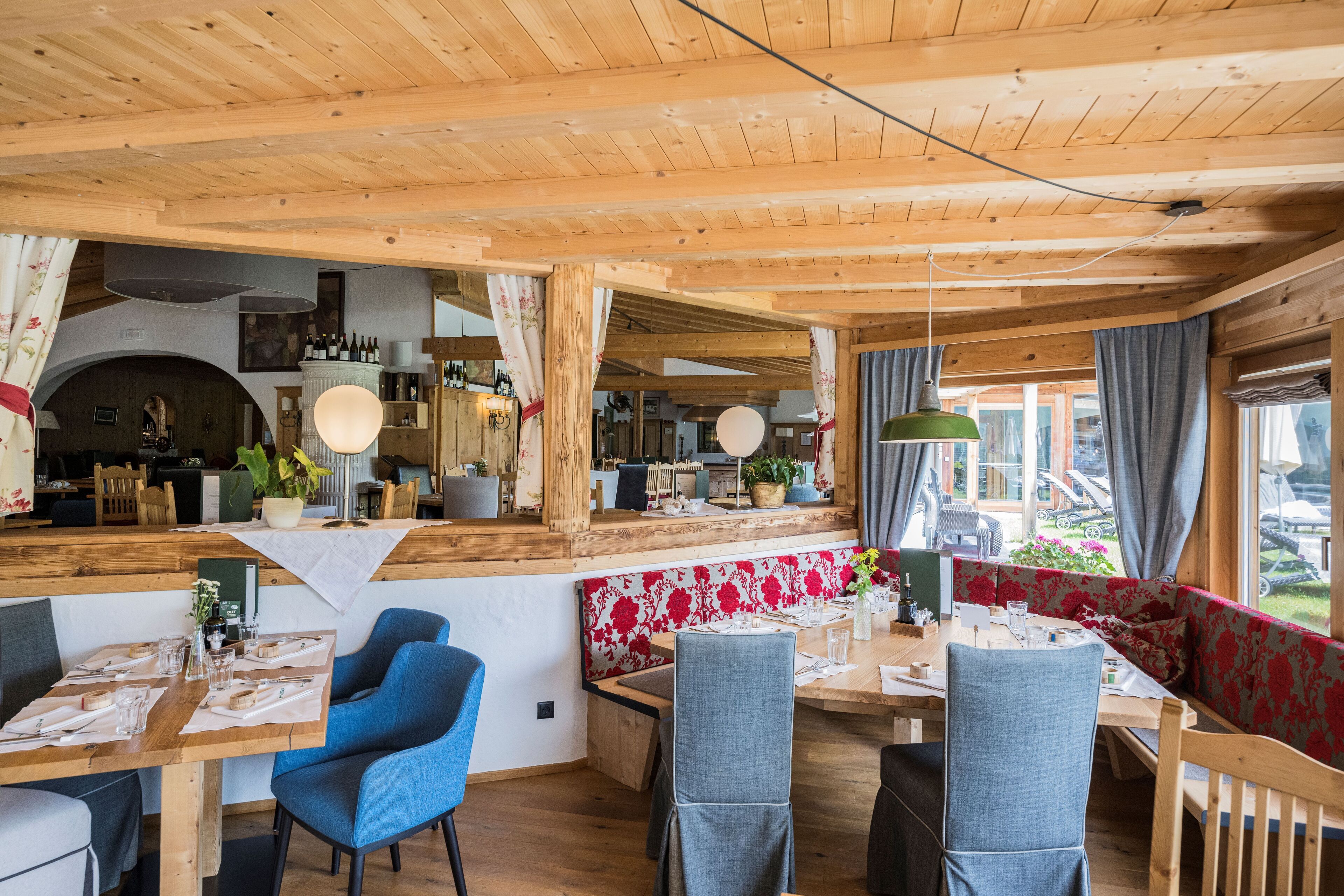 Un interior de madera con comedor, asientos y una zona de bar.