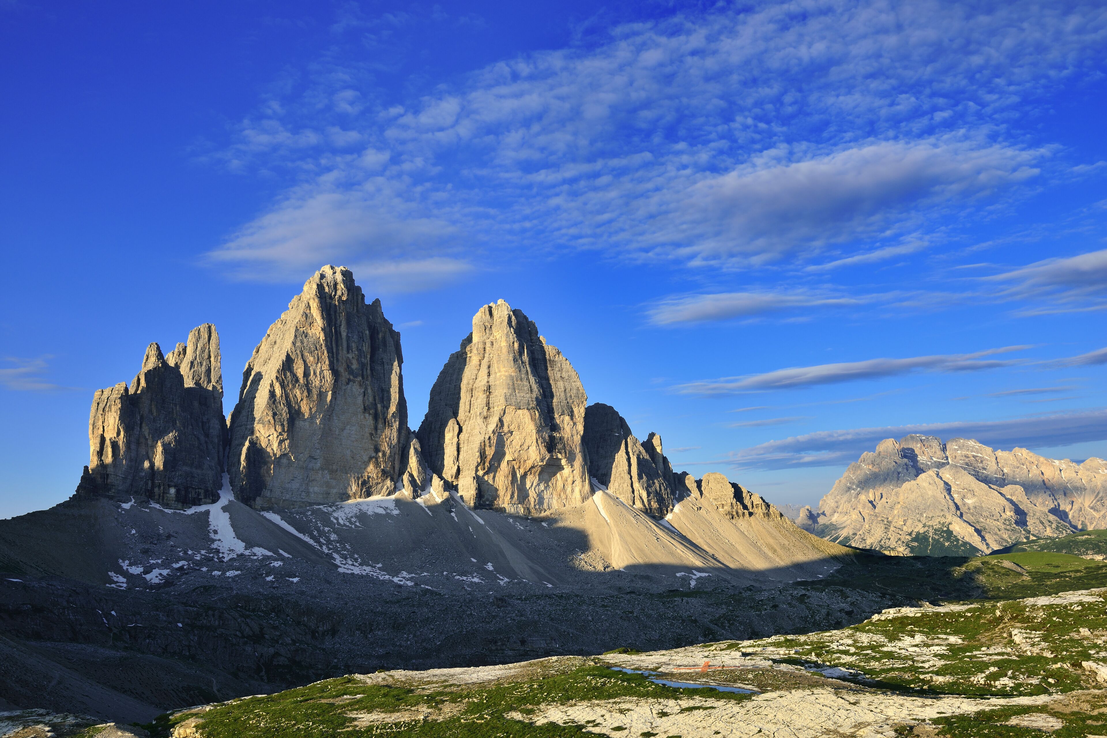 A mountainous landscape with prominent rock formations and a clear sky.