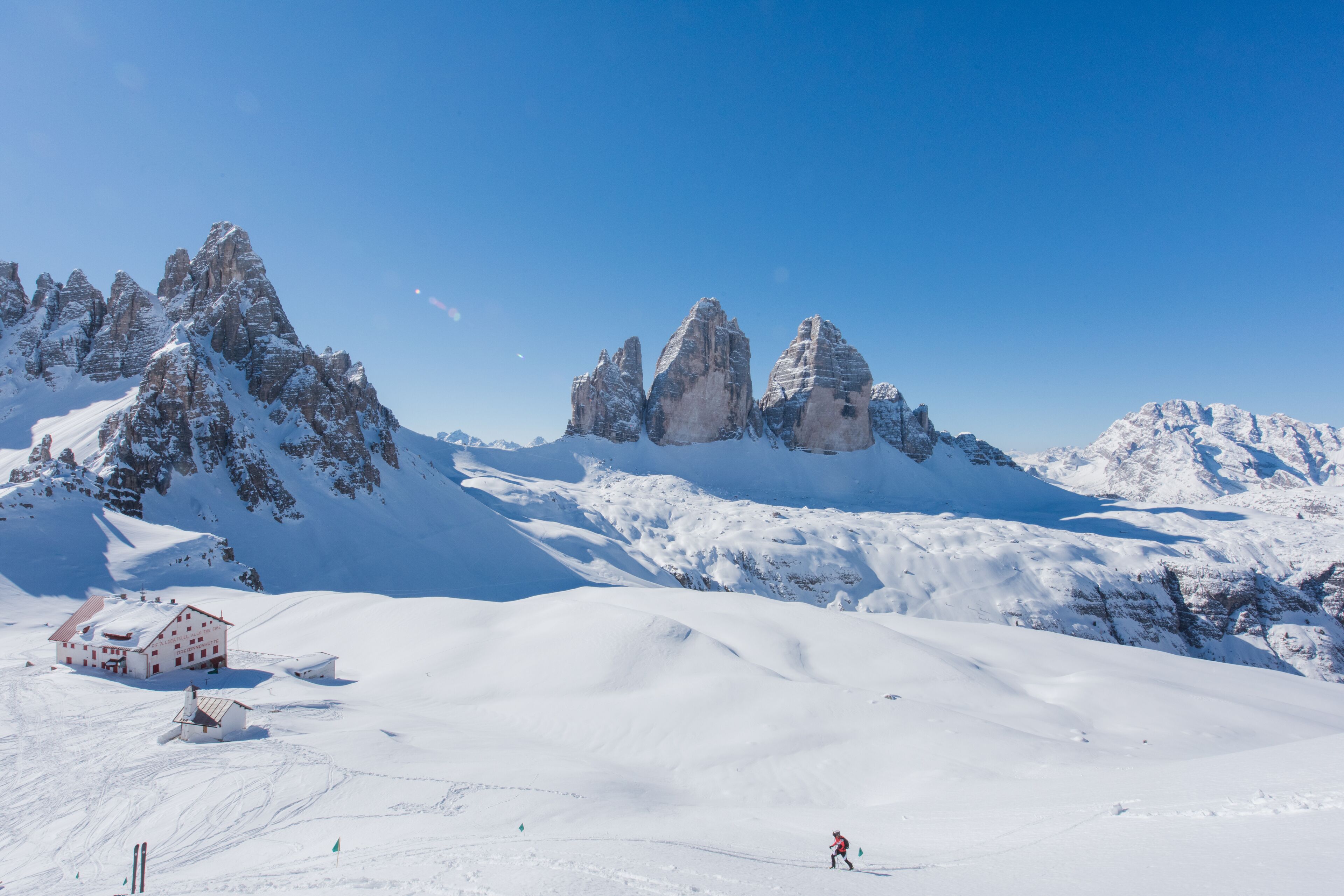 A snow-covered mountain with a ski resort, including a lodge and ski slopes.