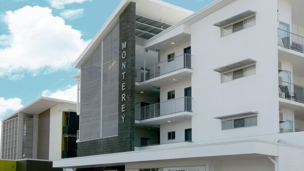 A modern hotel with a prominent 'MONTEREY' sign, multiple balconies, and a clean architectural design. - Monterey Moranbah (Moranbah)