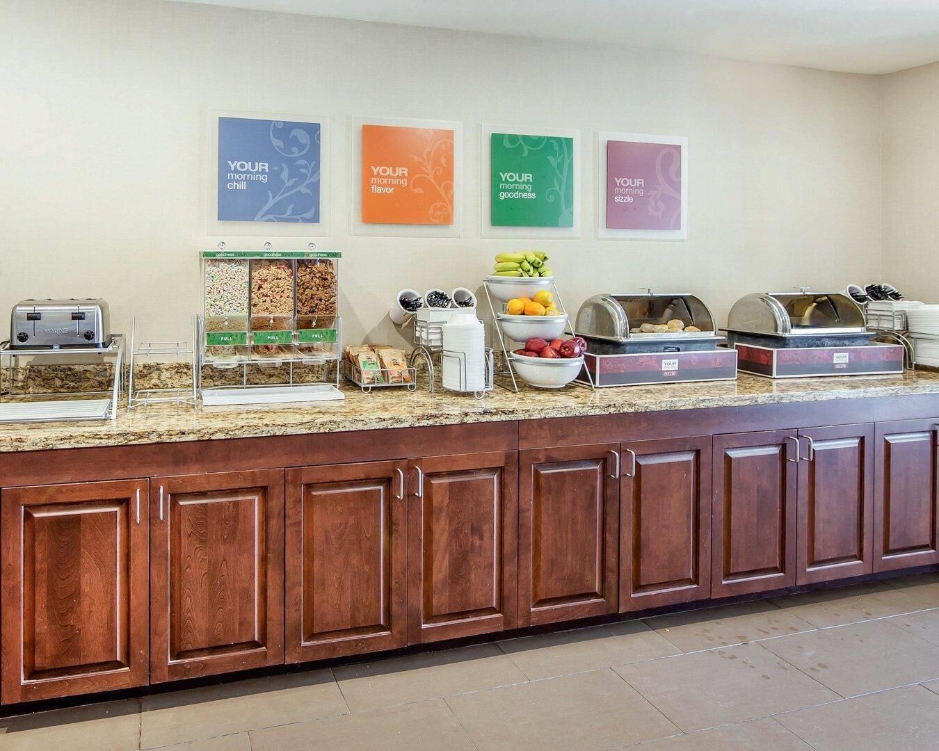 A breakfast buffet with various food options, a toaster, and a coffee station.