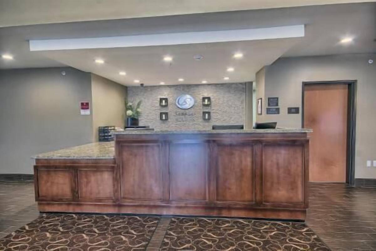 A reception area with a marble counter, a stone wall, and a door.