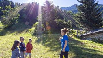 Explore the great outdoors with family-friendly activities amidst lush greenery and majestic mountains.