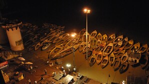 A nighttime view of a dock with numerous boats lined up. - Shri Guest House (Varanasi)