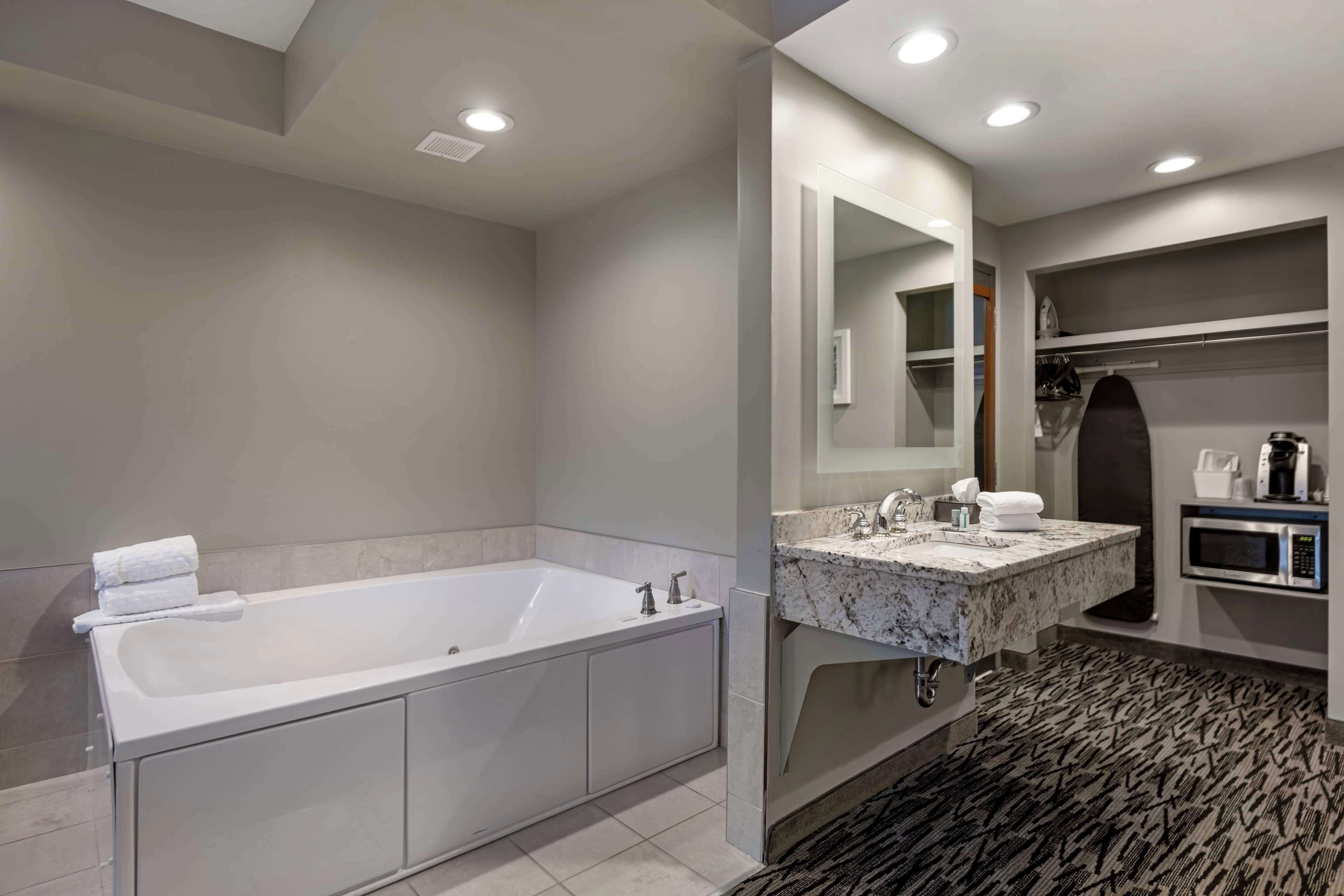 suite, 1 king bed, non smoking, jetted tub | desk, laptop workspace, blackout curtains, iron/ironing board