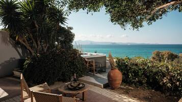 Superior Studio Suite, 1 Bedroom, Sea View, Beachfront | Living area | 32-inch plasma TV with satellite channels, TV, DVD player