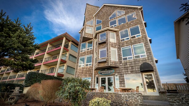A multi-story building with a restaurant named "Maggie's on the Mountain" at the ground level.
