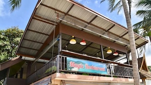 A two-story building with a sign reading "Magic Restaurant" on the ground floor. - Magic Resort (Koh Samui)