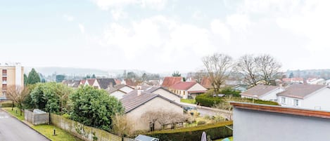 A residential area with houses, a road, and a fence.