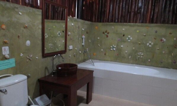A bathroom with a toilet, sink, and bathtub.