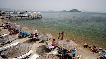 On the beach, sun loungers, beach umbrellas