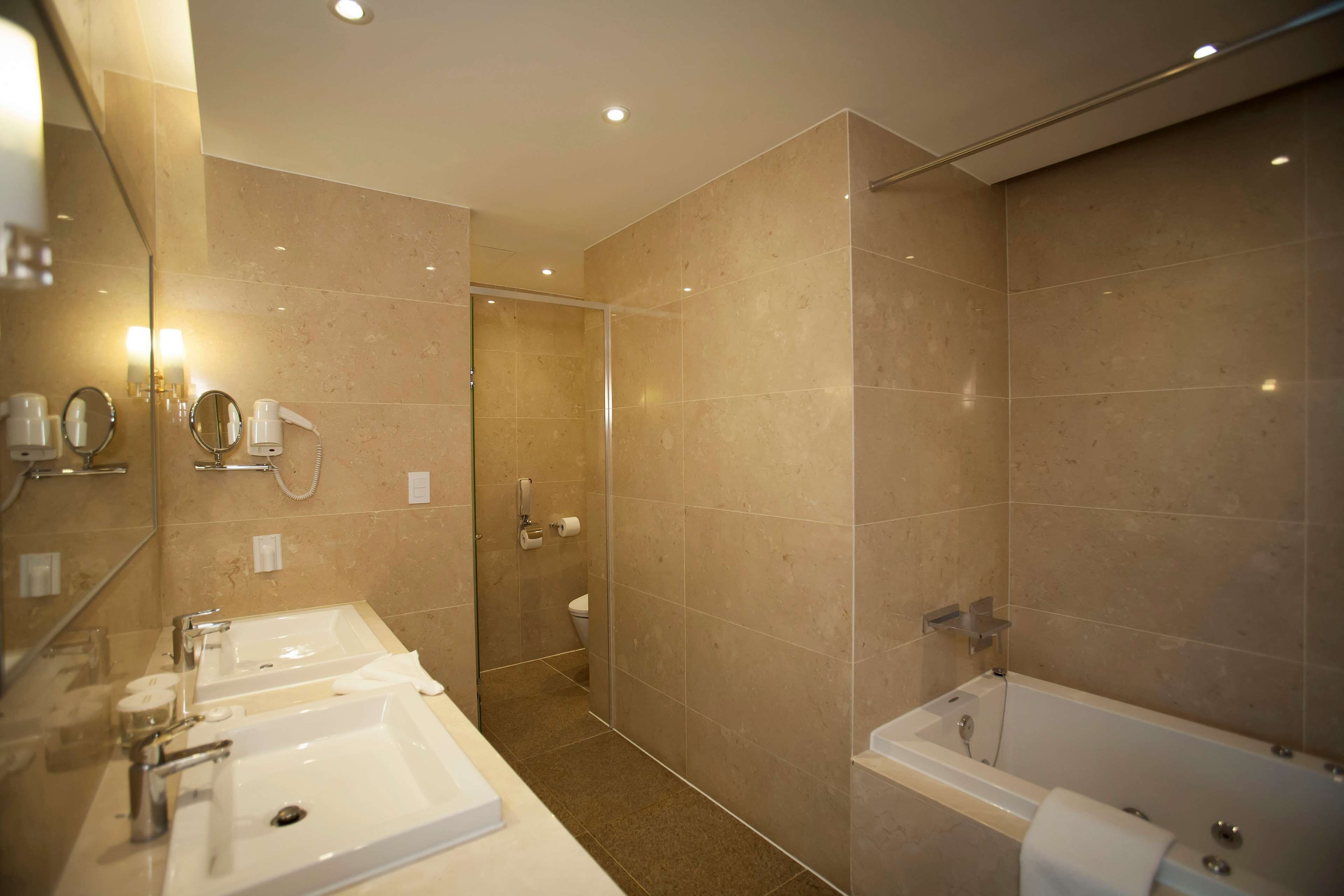 executive suite, 1 king bed, non smoking, refrigerator & microwave | bathroom | hair dryer, bathrobes, slippers, bidet