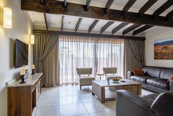 Four Bedroom Villa with Splash Pool | Living area | Flat-screen TV - The Kingdom Resort (Moses Kotane)