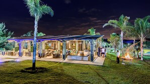 A well-lit outdoor lounge area with seating and a fire feature. - The Kingdom Resort (Moses Kotane)