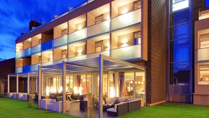 A modern multi-story hotel with outdoor seating areas and a covered patio. - Hotel Kaj (Marija Bistrica)