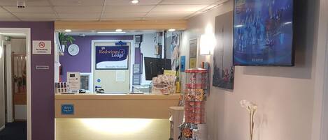 A reception area with a 'No Smoking' sign, a clock, and a 'Keys' sign.
