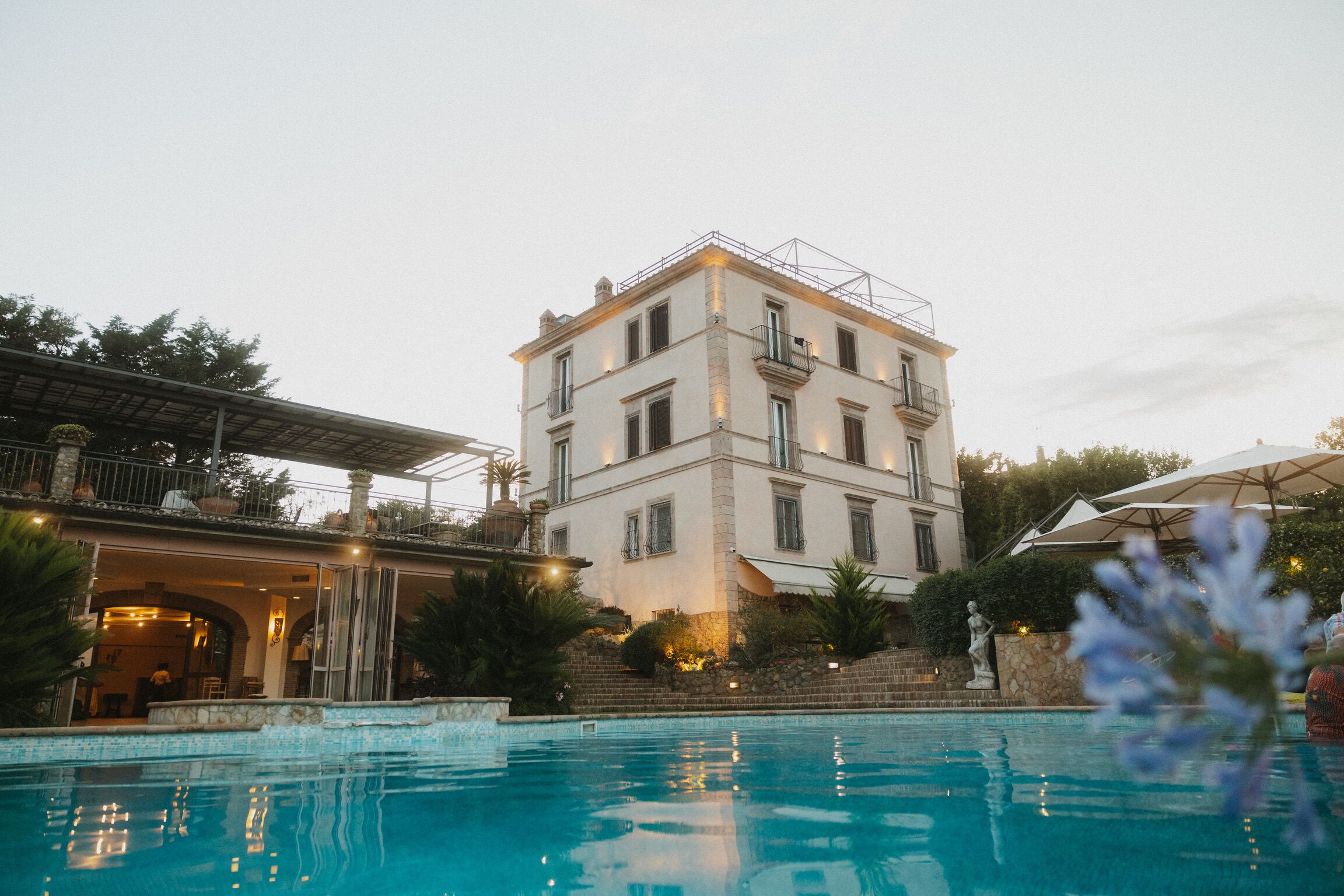 A pool area with a building in the background.