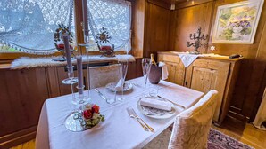 A dining table set with white tablecloth, glassware, and a bouquet of flowers. - Hotel da Beppe Sello (Cortina d'Ampezzo)