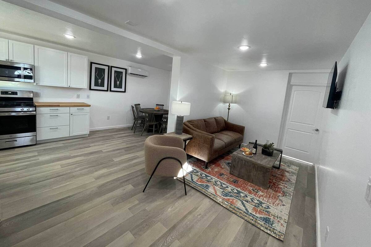 A modern apartment with a kitchen, dining area, and living room.