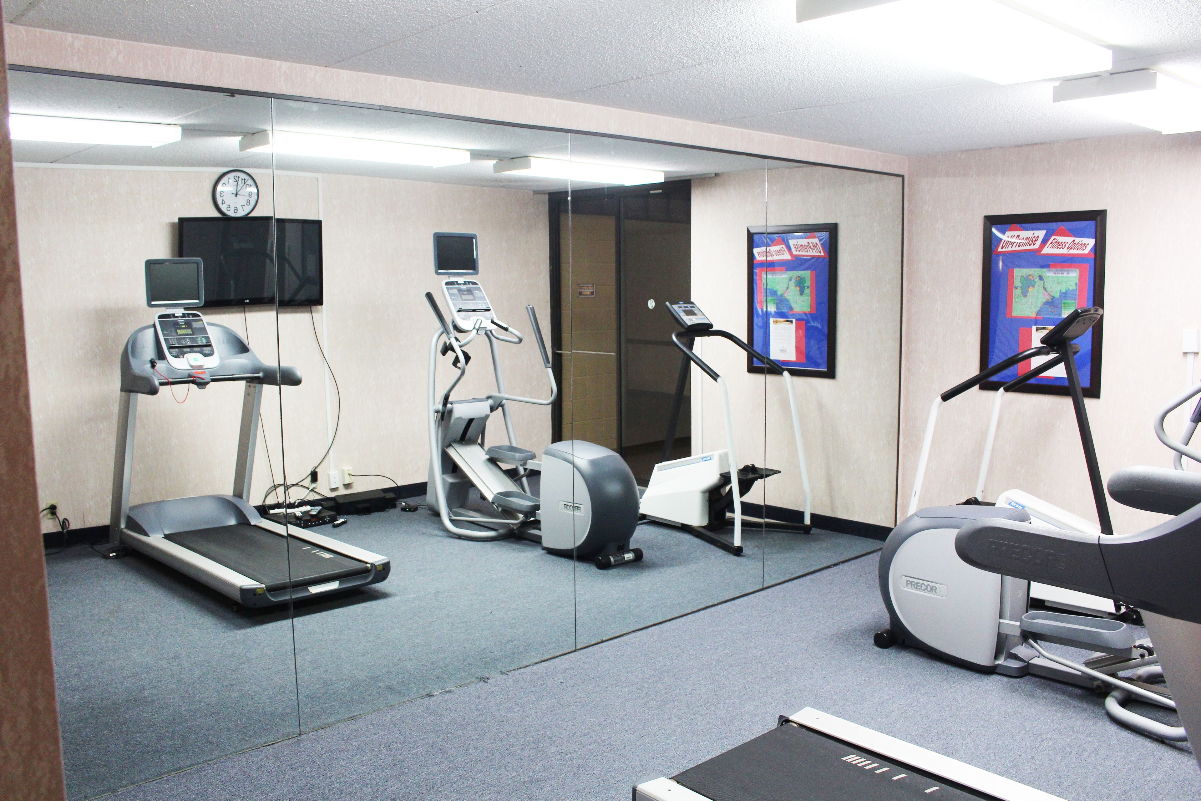 A fitness center with treadmills, elliptical machines, and a stationary bike.