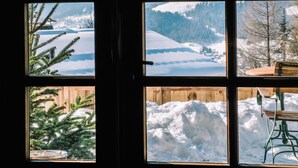 A window with a view of snow-covered mountains and a wooden fence. - La Ferme du Golf (Megeve)