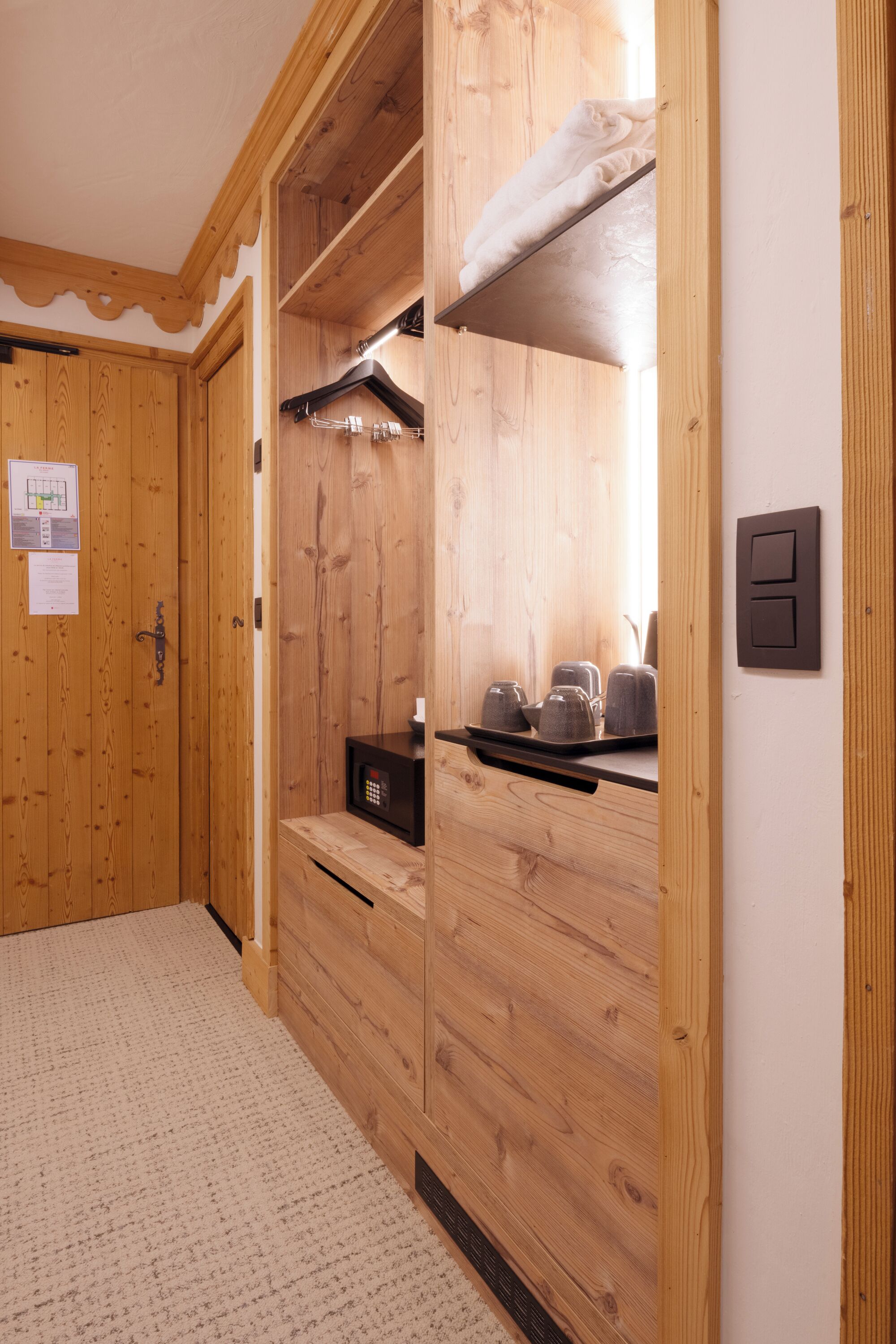 A wooden interior with a built-in microwave, a towel rack, and a door with a lock.