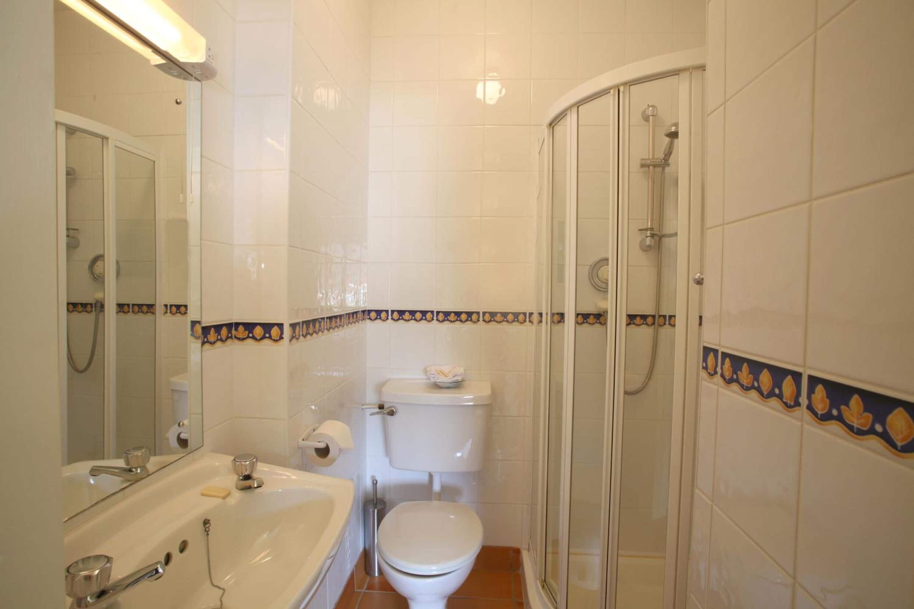 A bathroom with a bathtub, toilet, and shower.