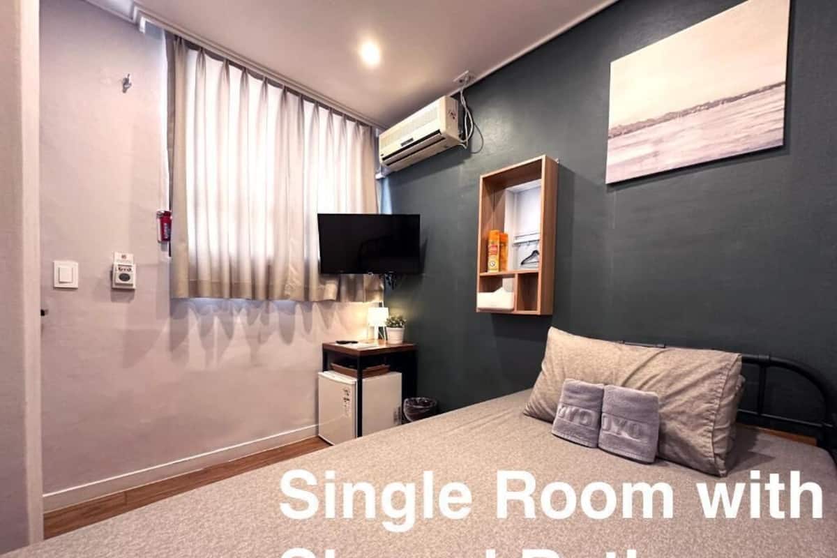 Economy Single Room, Shared Bathroom | Down comforters, Select Comfort beds, desk, blackout drapes