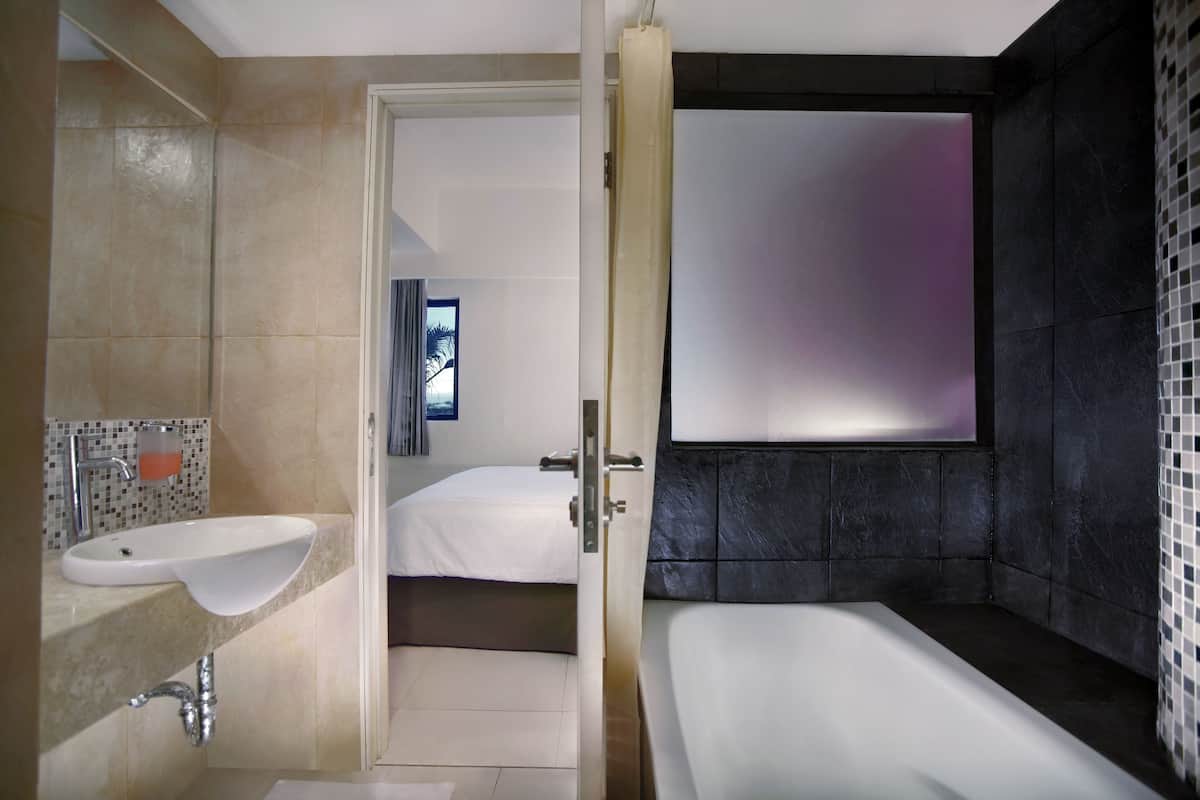 deluxe room | bathroom | shower, rainfall showerhead, free toiletries, towels