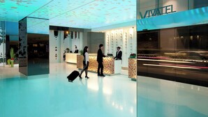 A modern hotel lobby with a reception desk, a glass wall, and a clean, polished floor. - Vivatel Kuala Lumpur (Kuala Lumpur)