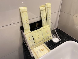 A bathroom with a white bathtub, a towel rack holding multiple Dreamtel branded towels, and a soap dish with a bar of soap.