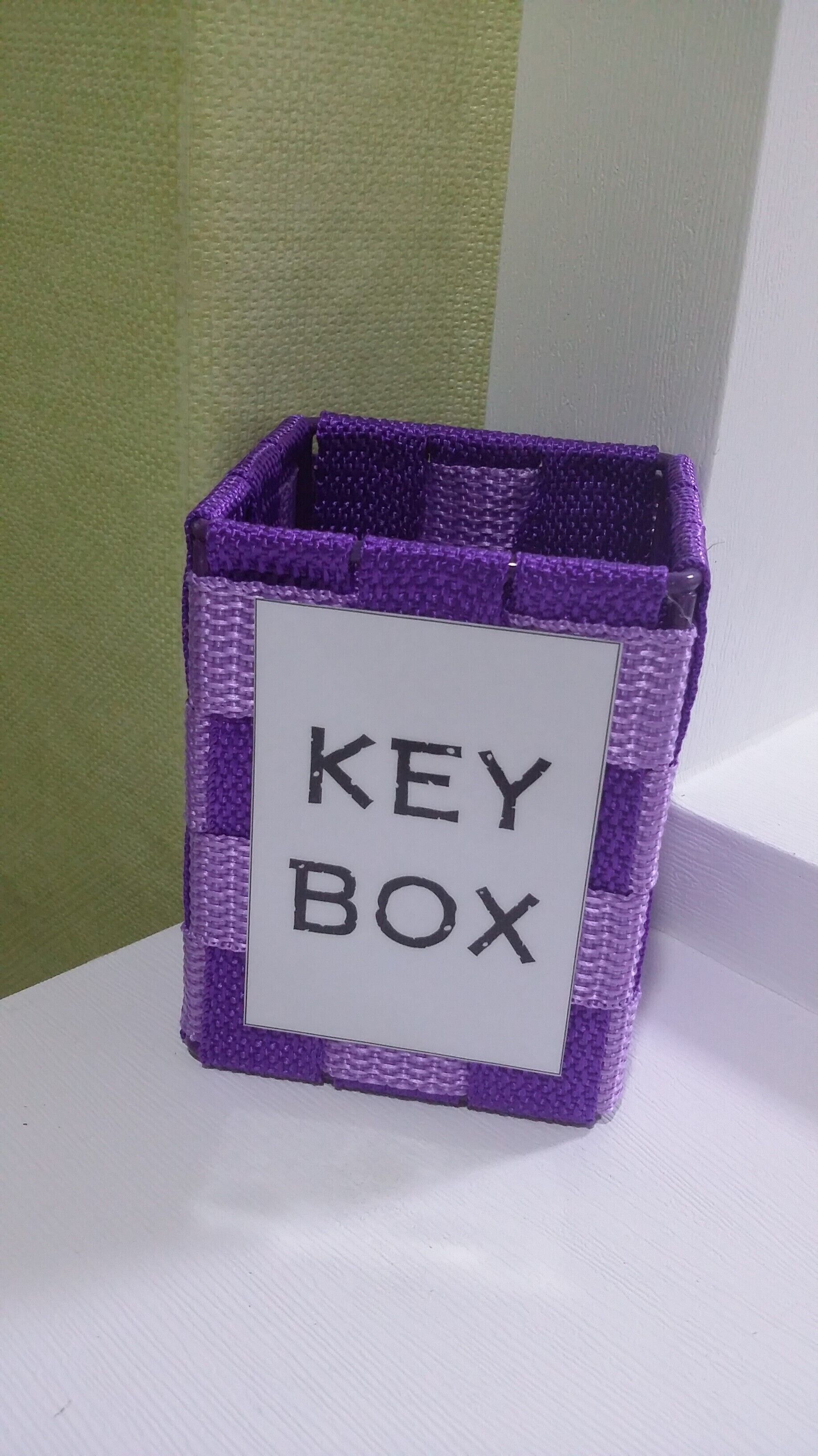 A purple key box with a white label that reads "KEY BOX".