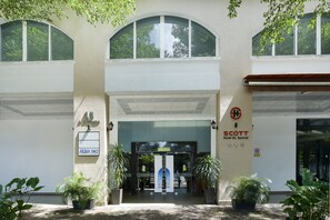 A hotel entrance with a sign for 'Scott Hotel KL Sentral,' a reception desk, and potted plants. - Palette KL Sentral Station Formerly Scott Hotel (Kuala Lumpur)