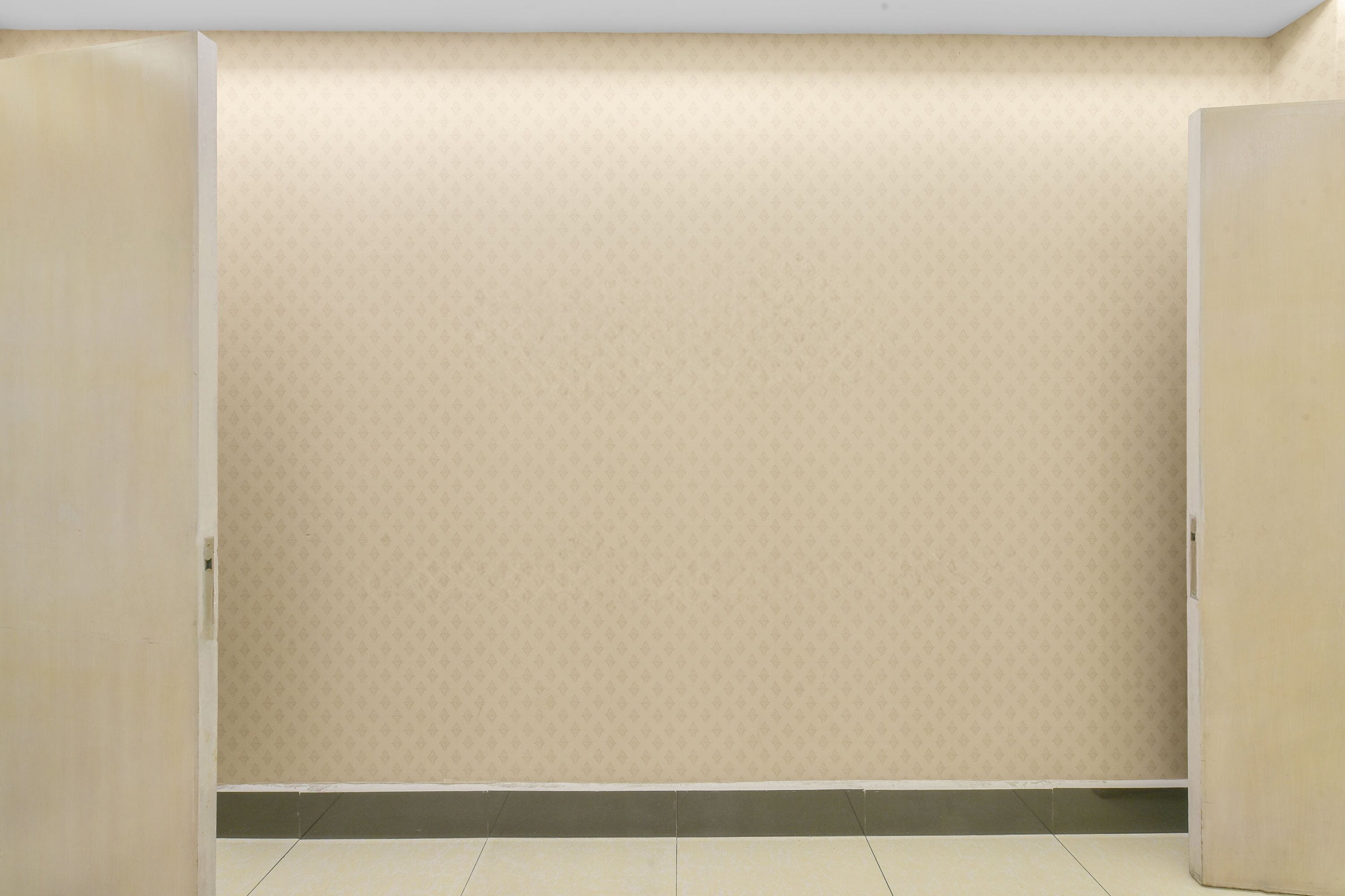 A room with a patterned wallpaper, a tiled floor, and a partially open door.
