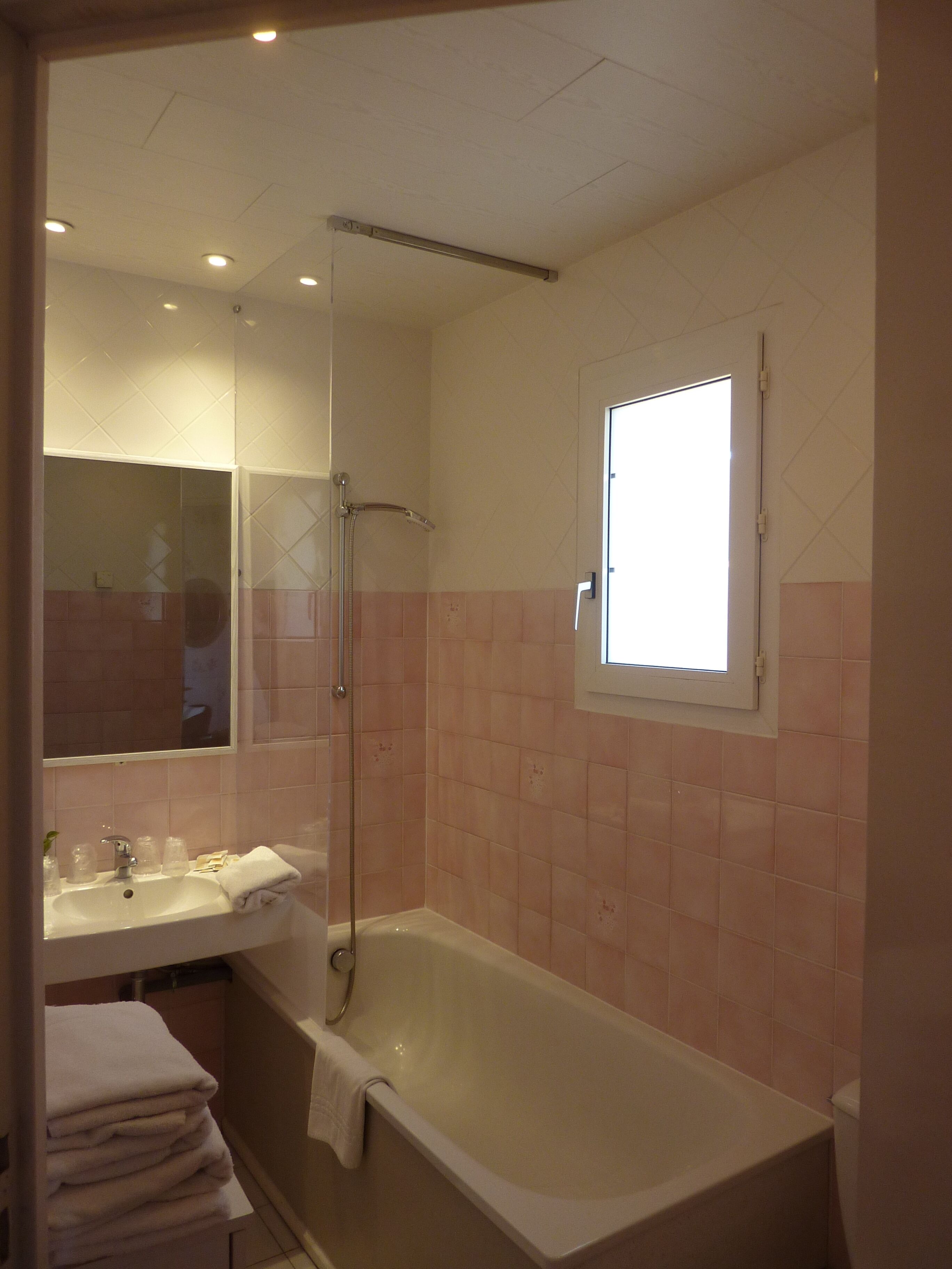 A bathroom with a bathtub, a sink, and a shower.