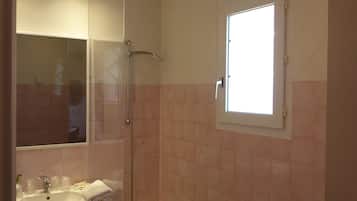 A bathroom with a bathtub, a sink, and a shower.