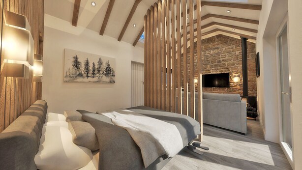 A modern bedroom with a bed, a sofa, a fireplace, and a stone wall. - Bankton House Hotel (Livingston)