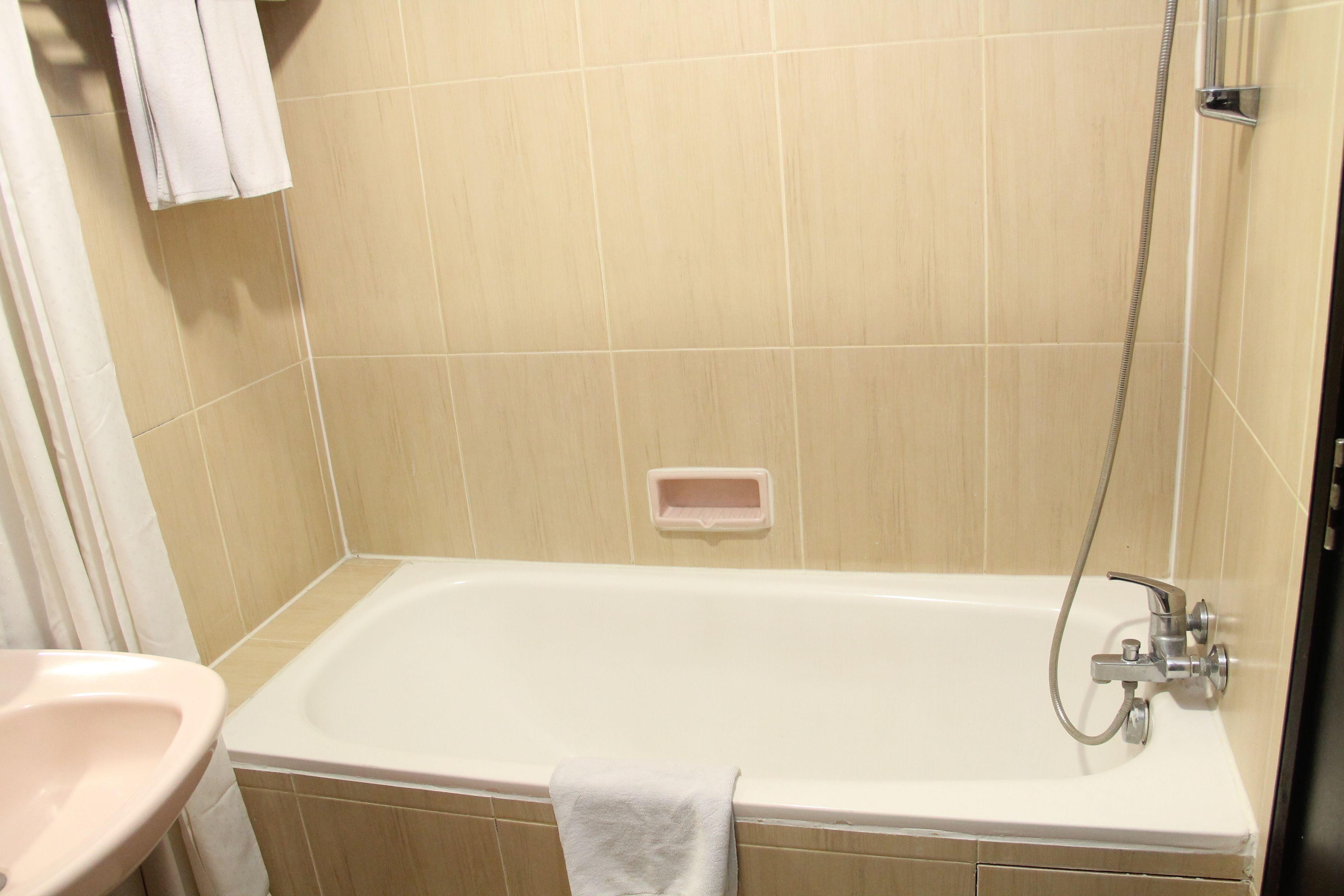 A bathroom with a bathtub, a sink, and a shower.