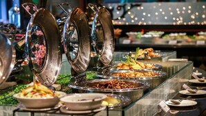 Un buffet proposant divers plats présentés dans des récipients de service en métal.