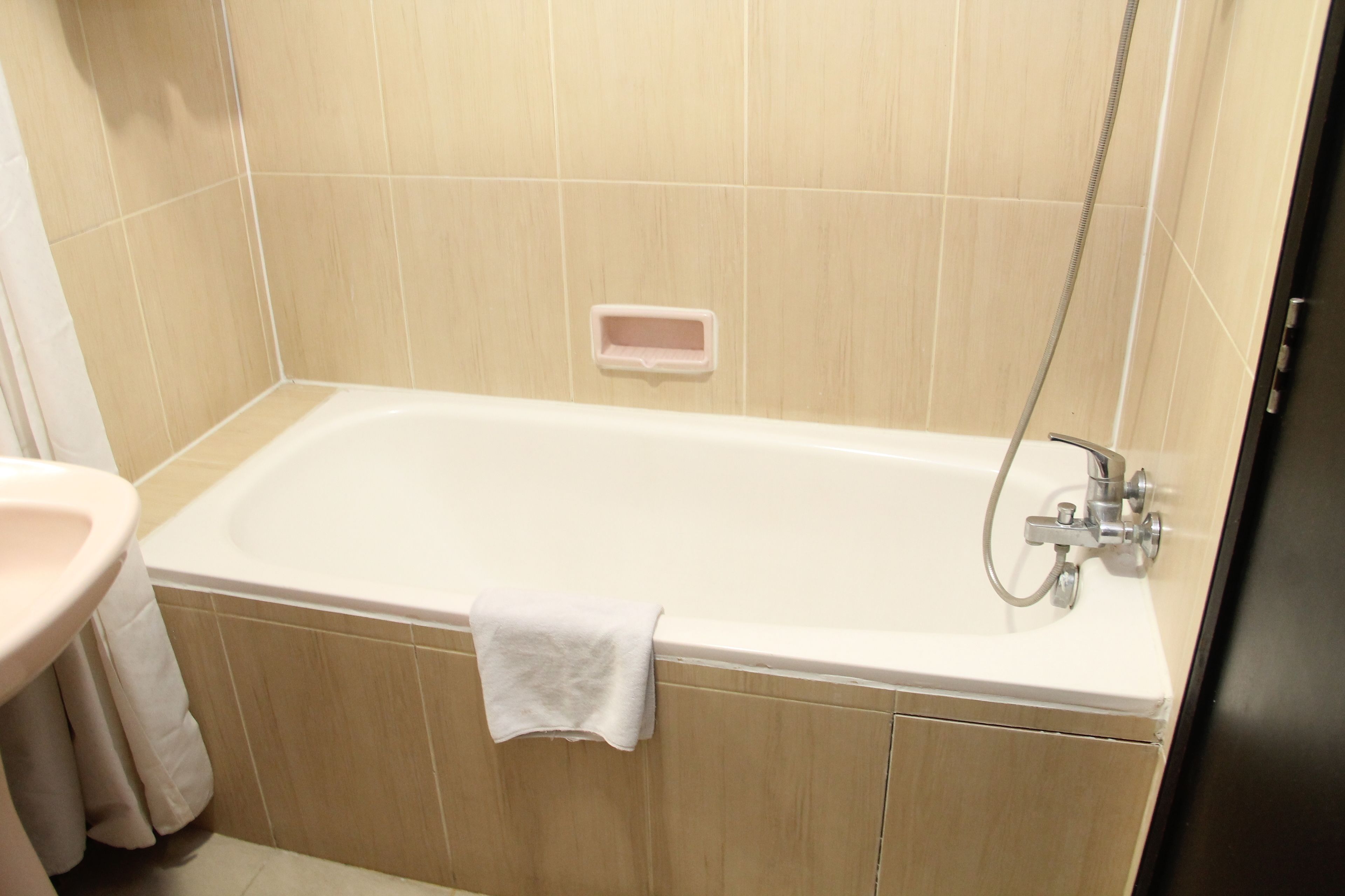 A bathroom with a bathtub, a sink, and a shower.
