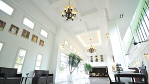 A spacious lobby with high ceilings, large windows, and modern chandeliers. - The Sterling (Malacca City)