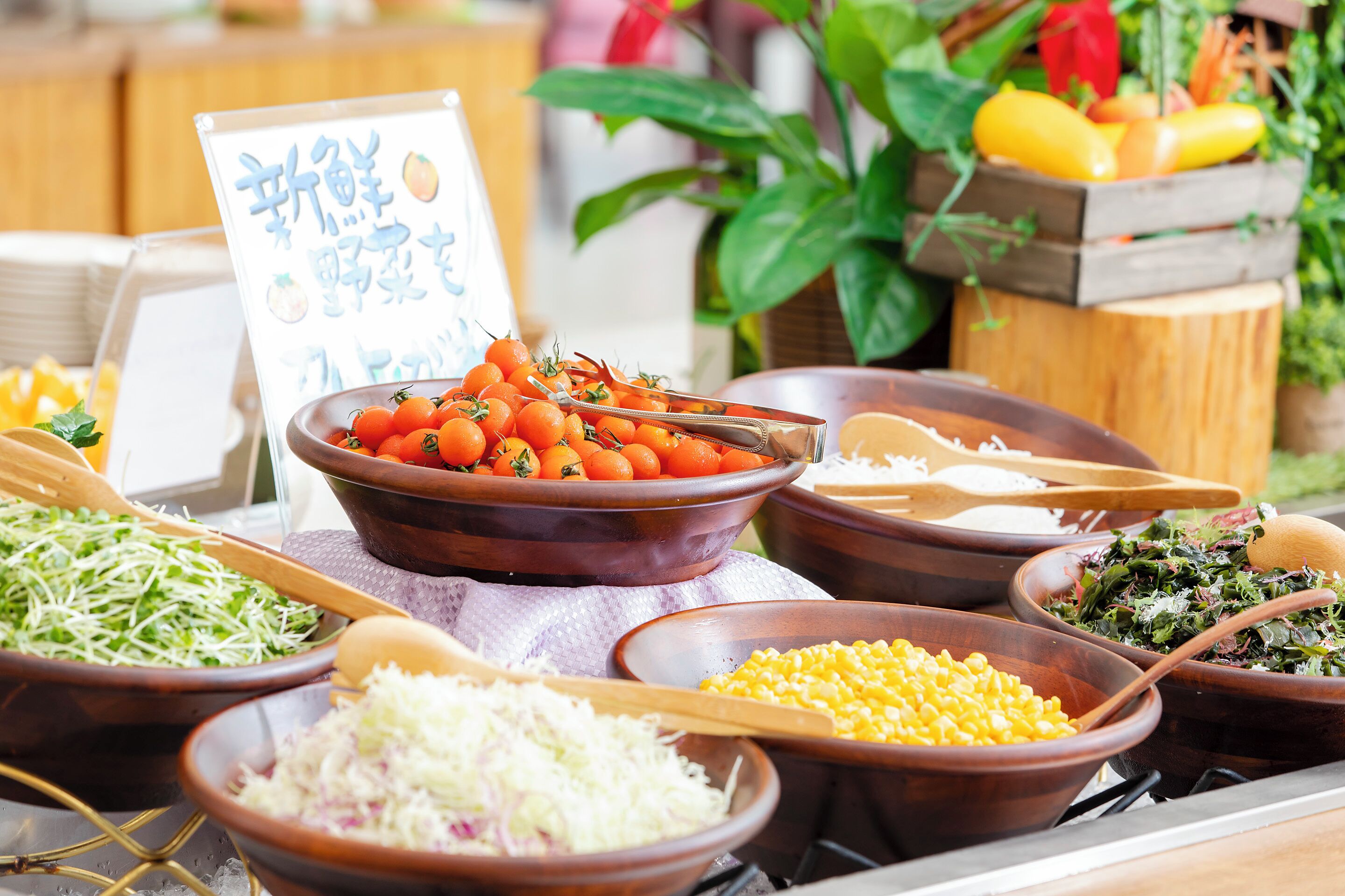 Un bufé con distintos alimentos en recipientes, incluyendo verduras y cereales.
