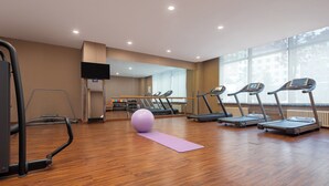 A gym with treadmills, a stationary bike, and a yoga mat. - Holiday Inn Express Changbaishan by IHG (Baishan)