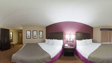 Une chambre d’hôtel avec deux lits, une télévision, un bureau et un mini-bar.