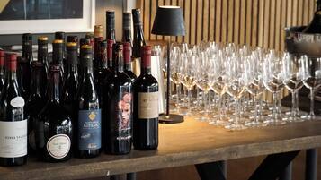 A bar area with multiple wine bottles and glasses.