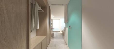 A modern hotel corridor with a wooden wardrobe, a bench, and a view of a balcony.